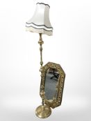 An ornate brass octagonal mirror and a standard lamp