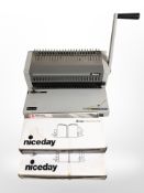 An Ibico comb binding machine and three boxes of binding rings.