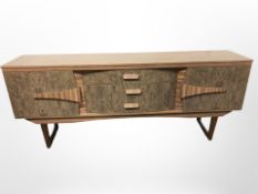 A 20th century teak veneered low high gloss sideboard,