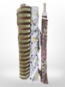 Three rolls of upholsterer's fabric / material, width approximately 140 cm, length unknown.