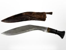 A Kukri knife with one smaller knife, in leather sheath, blade 32cm.