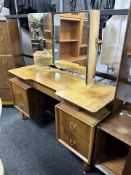A 20th century G-plan teak mirrored backed dressing table designed by E.