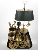 A brass twin-sconce table lamp, a further lamp base, brass candelabrum, trivets,
