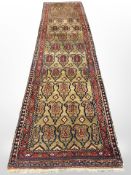 A Kurdish runner, North-West Iran, with central columns of boteh on a tan field,