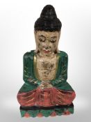 A carved and painted Buddha figure,