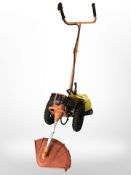 A Sherpa petrol push along grass strimmer and several spools of cable