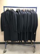 A rail of navy blue striped coats, various sizes.