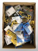 A box containing a large quantity of new fishing equipment including hooks and lines, lures,