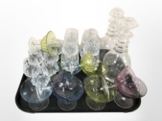 A group of clear and coloured drinking glasses, pair of decanters.