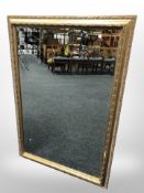 A gilt and bevelled overmantel mirror 102 cm x 72 cm