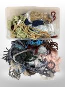 A large quantity of tasselled curtain tiebacks in various colours.