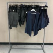 A rail of Gent's striped waistcoats and grey striped formal trousers, various sizes.