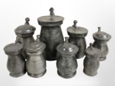 Eight 18th-century graduated pewter tankards, tallest 16.5cm.