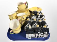 20 pieces of Royal Winton tea china on yellow ground, and 13 KLM Bols ceramic decanters (empty).