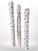 Three rolls of upholsterer's fabric / material, width approximately 140 cm, length unknown.