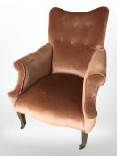 A late Victorian mahogany library armchair in the Howard style upholstered in pink dralon,