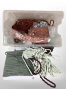 A large quantity of tasselled curtain tiebacks in various colours.