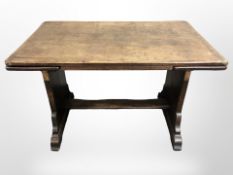 An early 20th century oak pull out extending table,