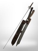 A machete in leather-mounted scabbard, length 56cm, together with a further curved knife in sheath,