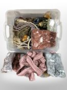 A large quantity of tasselled curtain tiebacks in various colours.