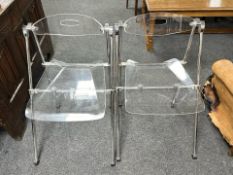 A pair of chrome framed clear plastic folding ghost chairs