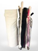 Approximately 20 rolls of material and a large roll of polyester