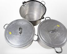 Two aluminium twin-handled cooking pans with lids, diameter 31cm, and a further swing-handled pan.