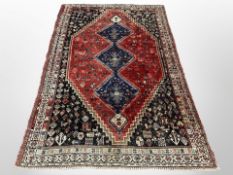A Kashgai rug, South-West Iran, the three indigo medallions upon a madder central field,