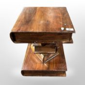 A contemporary lamp table in the form of a stack of books