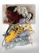 A large quantity of tasselled curtain tiebacks in various colours.