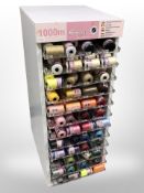 A haberdashery stand containing many spools of thread,