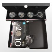 A cased set of four Royal Mint London 2012 £5 coins, plus another similar.