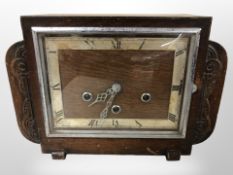 An Art Deco carved oak mantle clock,