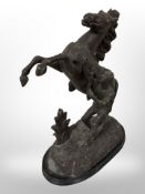 A Victorian painted cast-metal figure group of a rearing horse, height 40cm.