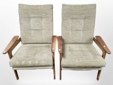 A pair of 1960's teak framed lounge armchairs in olive fabric,