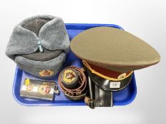 A reproduction Soviet officer's cap, a further Ushanka hat, set of drinking tots in leather pouch,