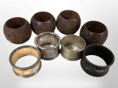 A group of carved hardwood and silver-plated napkin rings.