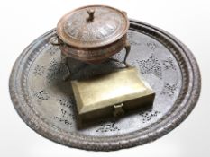 A 19th-century Indian embossed copper tripod food-warming dish,