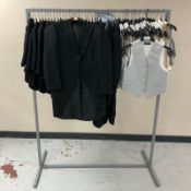 A rail of children's waistcoats and Gent's striped black formal blazers