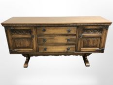 A Pratts of Bradford oak linen fold sideboard,
