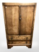 An early 20th century oak linen cabinet,