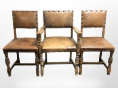 A set of six 20th century carved oak studded brown leather dining chairs