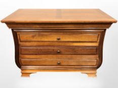 A contemporary hardwood four drawer chest,