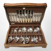 An oak canteen of EPNS cutlery.