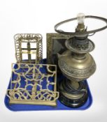 A brass oil lamp (converted), embossed brass picture frame, further easel frames, reading stand.