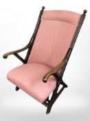 A mahogany X-frame armchair
