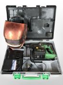 A Hitachi drill in box, together with a welding mask.