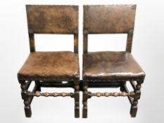 A pair of Edwardian oak studded brown leather dining chairs