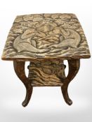 An early 20th century carved beech occasional table, the top depicting three monkeys 'See no evil,