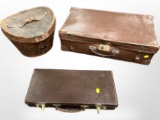 A Victorian leather top hat box and two suitcases.